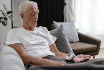 A old man checking health wearing a device in hand